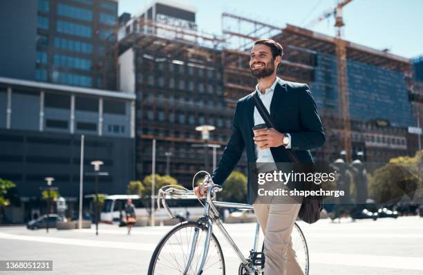 shot of a young businessman traveling through the city with his bicycle - coffee bag stock pictures, royalty-free photos & images