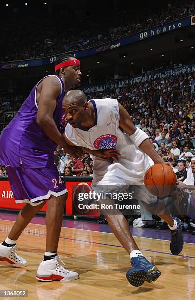 Vince Carter of the Toronto Raptors drives around Morris Peterson of the Toronto Raptors during the Vince Carter Charity All Star Game at the Air...