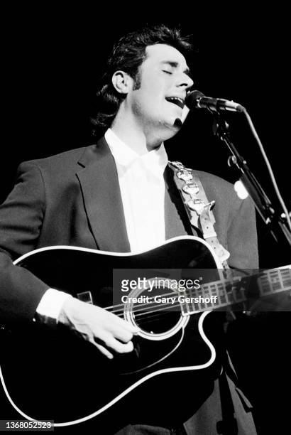 View of American Country musician Vince Gill plays acoustic guitar, as he performs onstage at the Beacon Theatre, New York, New York, May 15, 1991.