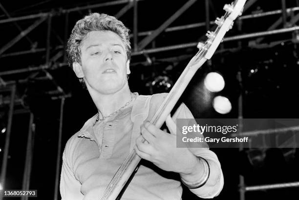 English-born Irish Rock musician Adam Clayton, of the group U2, plays bass guitar as he performs onstage, during the band's 'War' tour, at the...