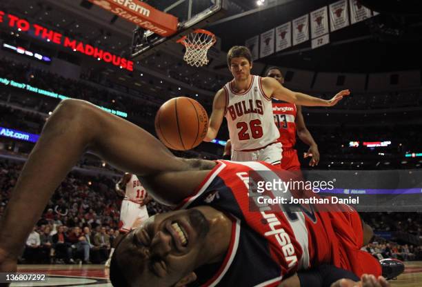 John Wall of the Washington Wizards hits the floor after taking a shot against Kyle Korver of the Chicago Bulls at the United Center on January 11,...