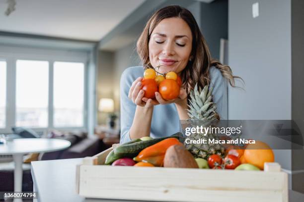 smelling organic vegetables - smelling food stock pictures, royalty-free photos & images