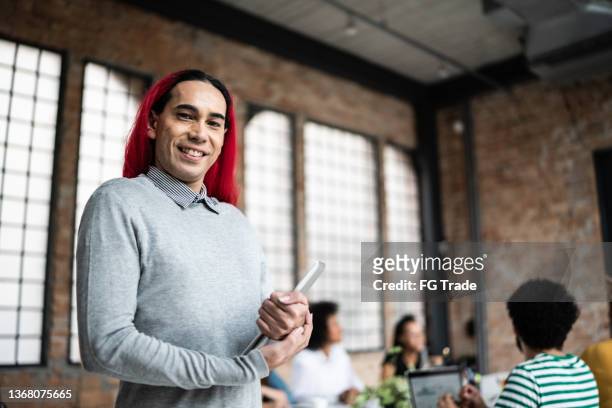 portrait of a mature man holding digital table in an office - reds training session stock pictures, royalty-free photos & images