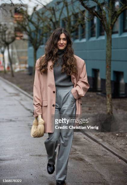 Ilirida Krasniqi is seen wearing grey turtleneck, grey pants, beige bag, oversized blazeroutside The Garment during Copenhagen Fashion Week...