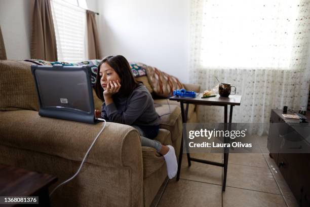 adolescent girl on her computer at home doing online schooling - zoom participant stock pictures, royalty-free photos & images