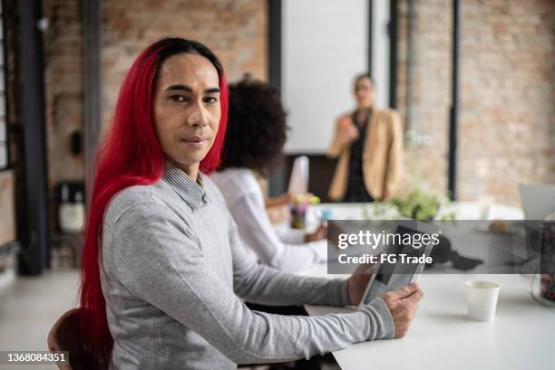 portrait of a business man during a meeting - androgynous professional stock pictures, royalty-free photos & images