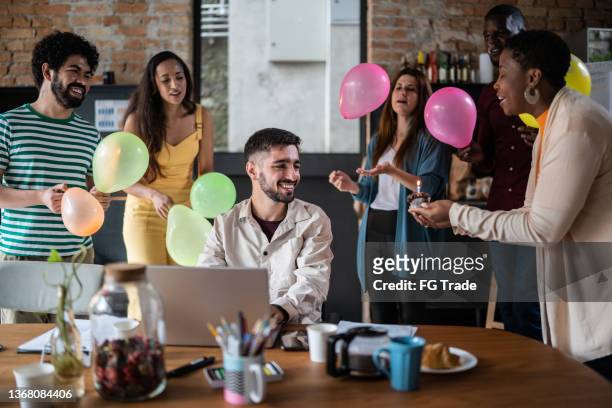 team celebrating business man birthday in the office - jubileum werk stockfoto's en -beelden
