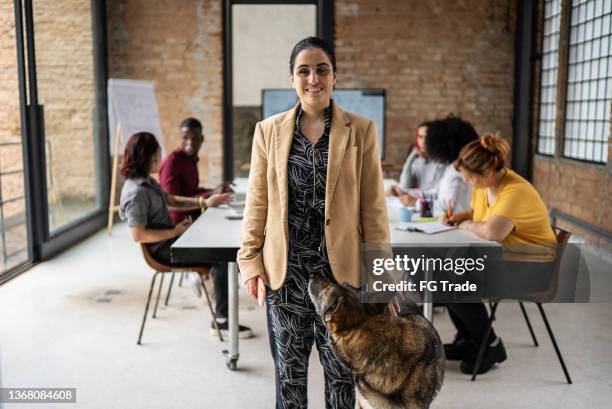 portrait of a visually impaired businesswoman in an office with guide dog - blind woman stock pictures, royalty-free photos & images