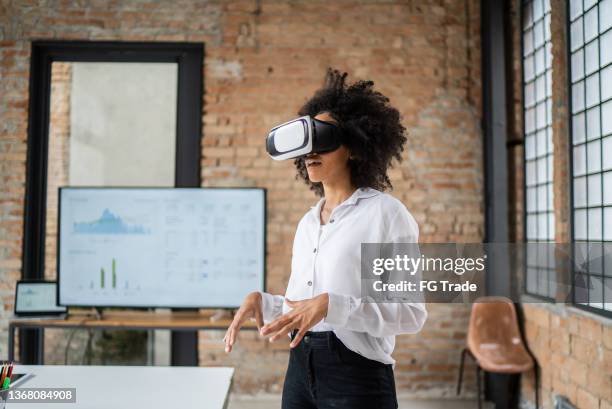 young woman in a virtual reality meeting in the office - voice remote stock pictures, royalty-free photos & images