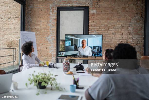 business team doing a video conference in the office - shareholder's meeting stock pictures, royalty-free photos & images