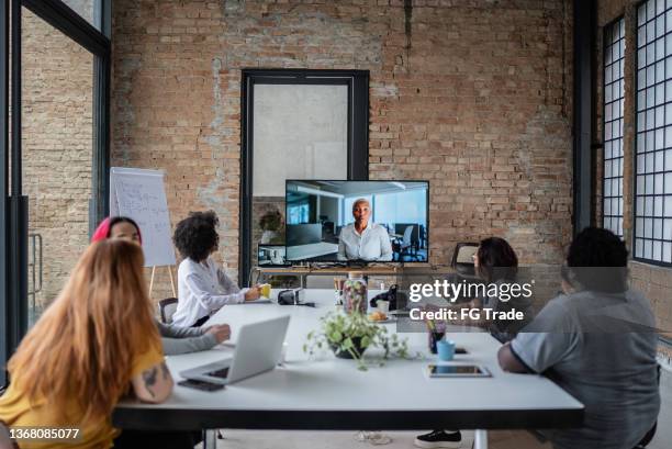 business team doing a video conference in the office - video conference stock pictures, royalty-free photos & images