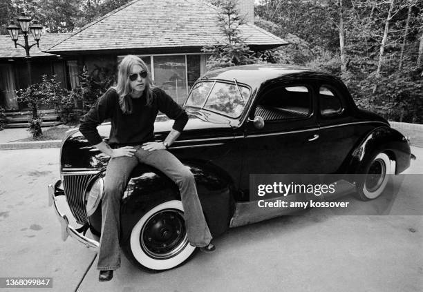 Gregg Allman sitting on his vintage Ford Deluxe in Macon, Georgia. Circa 1974 (