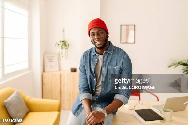portrait and close-up of african-american man at home office - ミッドアダルト ストックフォトと画像