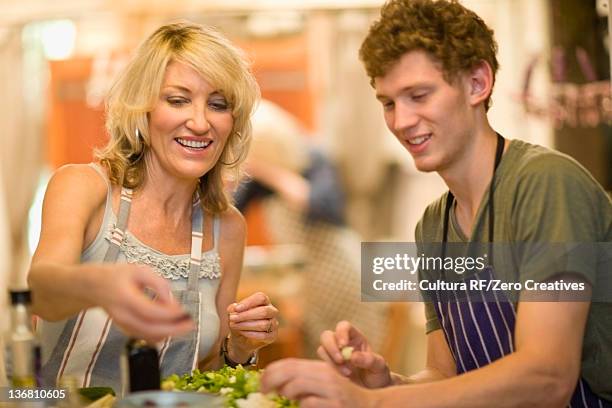 mother and son eating together - mature woman and son imagens e fotografias de stock