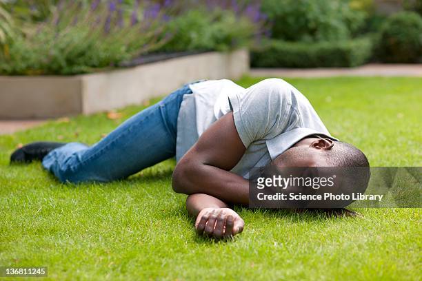 man in recovery position - unconscious stock pictures, royalty-free photos & images