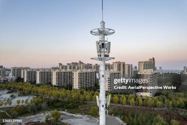 aerial view of 5g cellular communications tower at sunset - tower stock pictures, royalty-free photos & images