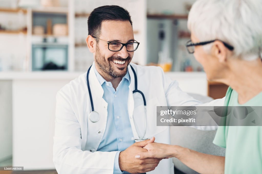 Smiling doctor with senior patient