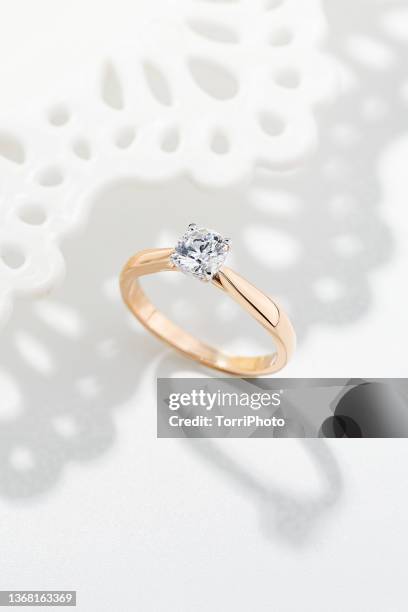 female wedding proposal diamond ring on white background - diamond jeweller stock pictures, royalty-free photos & images