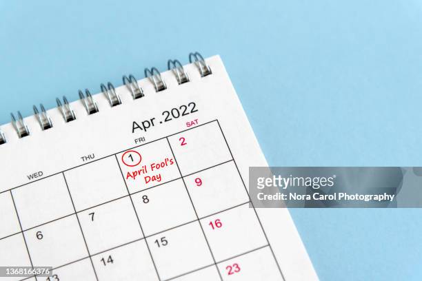 april fool's day circled on calendar - april fools day stockfoto's en -beelden