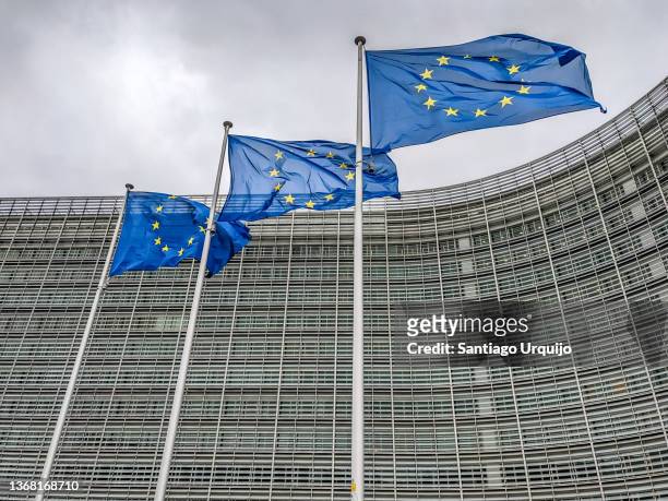 european union flags at berlaymont building of the european commission - european commission stock-fotos und bilder