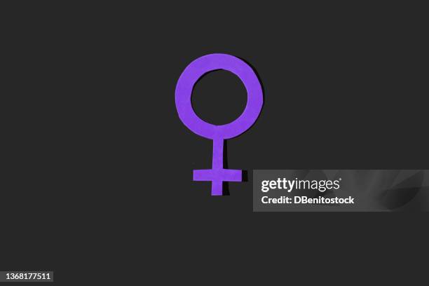 symbol of the woman in purple color on a black background. concept of women's day, empowerment, equality, inequality, hembrismo, activism and protest. - equality logo stock pictures, royalty-free photos & images