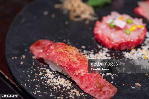 closeup on original japanese high quality kobe beef sushi - nigiri stockfoto's en -beelden