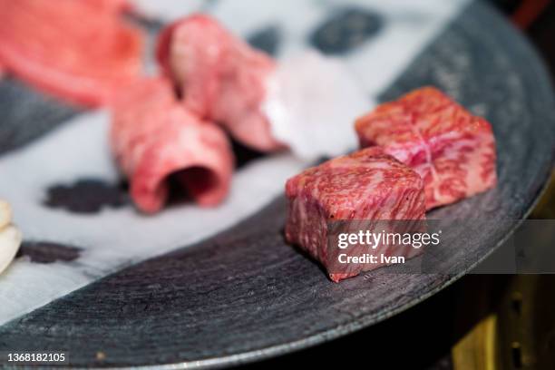 plate of marble texture of fresh raw wagyu beef. - japanese restaurant stock pictures, royalty-free photos & images