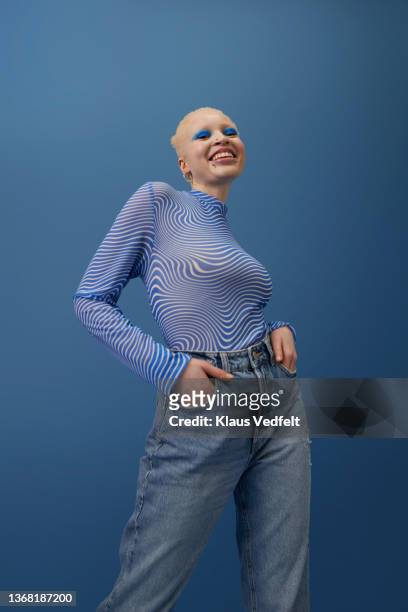 happy albino woman standing with hands in pockets - white skin stock pictures, royalty-free photos & images