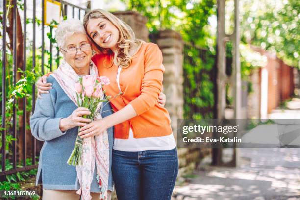 teenage girl is visiting her grandmother at home - volunteer aged care stock pictures, royalty-free photos & images