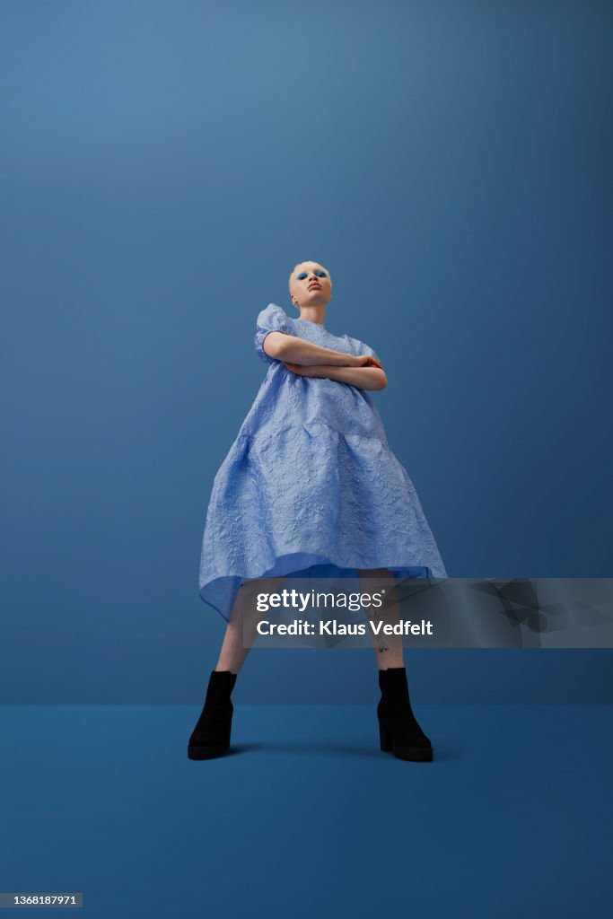 Confident albino woman standing with arms crossed
