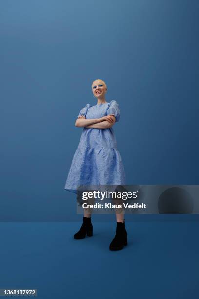 smiling albino woman standing with arms crossed - cosmetics isolated stock pictures, royalty-free photos & images