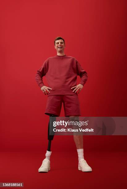 cheerful man standing with hands on hip - white t shirt studio stock pictures, royalty-free photos & images