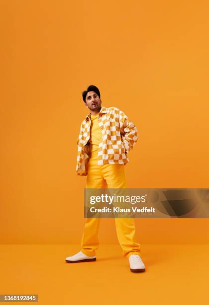 man with vitiligo standing with hands in pockets - yellow shirt stock pictures, royalty-free photos & images