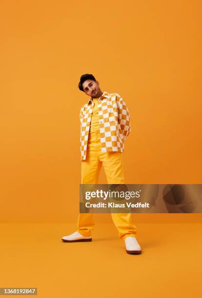 Man with vitiligo standing with hands behind back