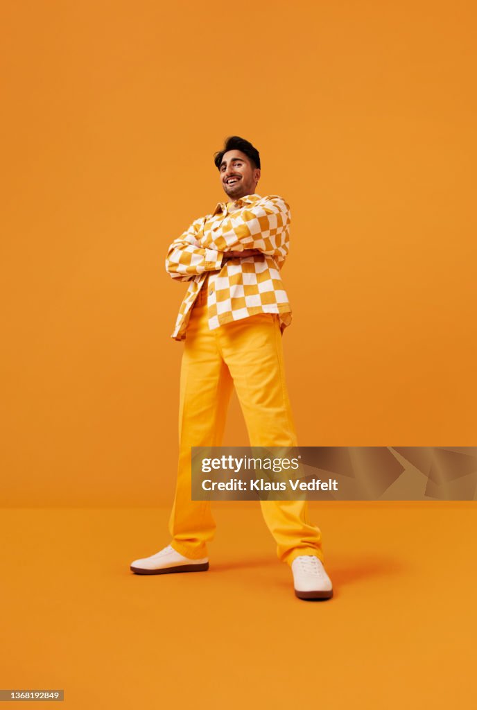 Happy man with vitiligo standing with arms crossed