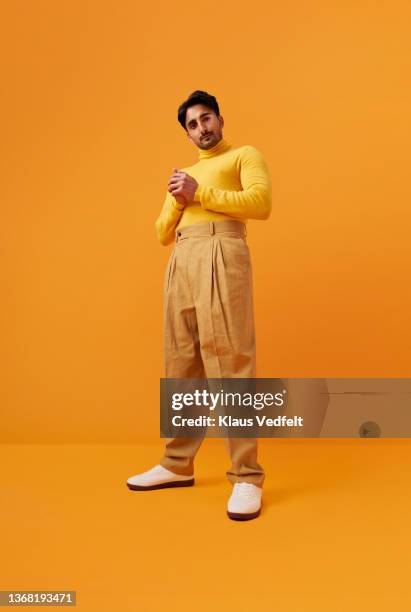 man with vitiligo standing with hands clasped - physical stance stock-fotos und bilder
