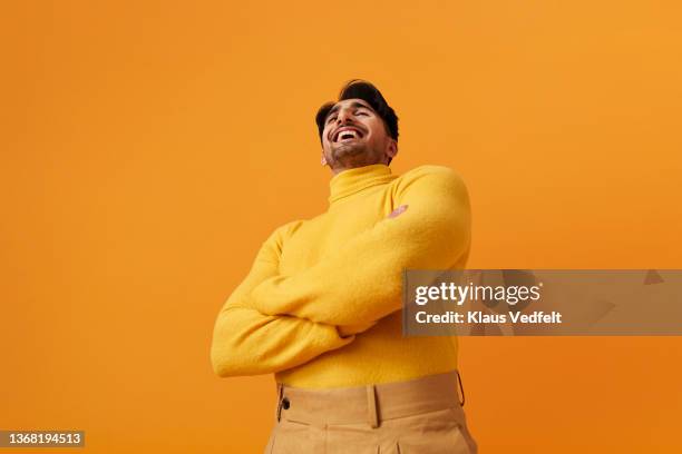 man with vitiligo laughing against yellow background - diversity color surge stock-fotos und bilder