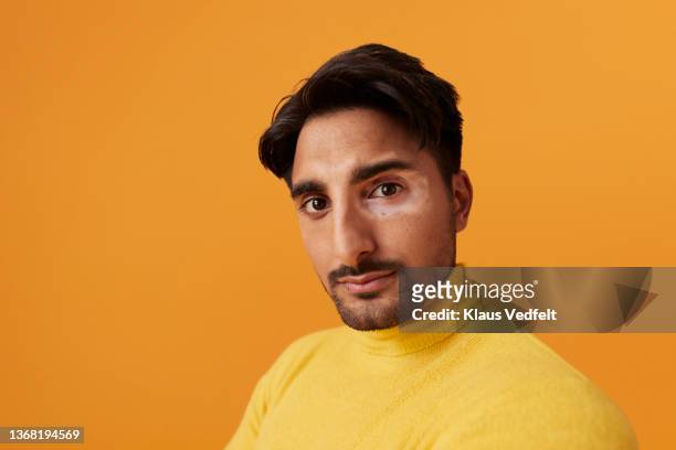 handsome man with vitiligo against yellow background - guy stubble stock pictures, royalty-free photos & images
