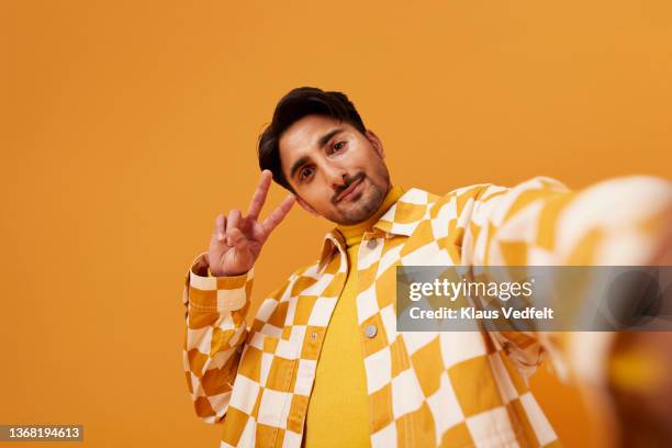 young man with vitiligo gesturing peace sign - cool guy stock pictures, royalty-free photos & images