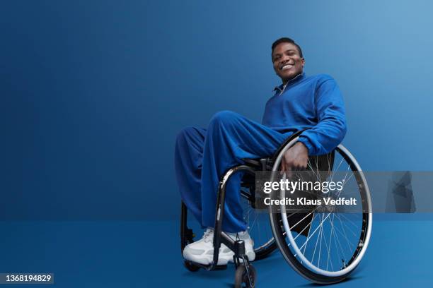 smiling man with disability sitting in wheelchair - low angle portrait stock pictures, royalty-free photos & images
