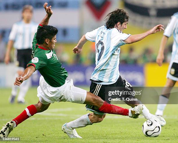 Carlos Salcido of Mexico slides in from the back to tackle Hernan Crespo of Argentina during the Round of 16 match at Zentralstadion in Leipzig,...