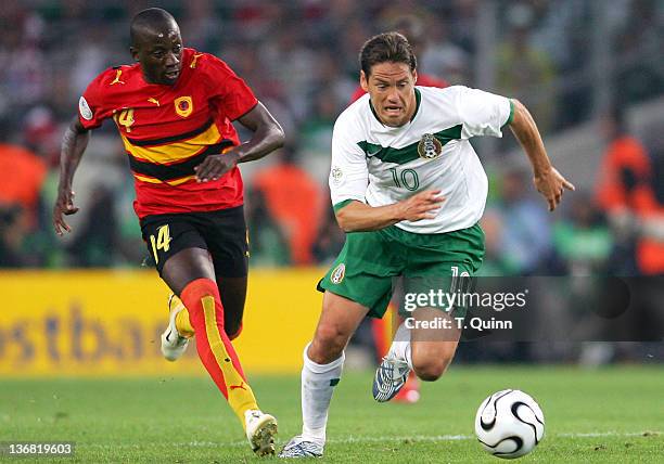 Guillermo Franco of Mexico races away from Mendonca of Angola as the teams played to a 0-0 tie in a Group D game in FIFA World Cup Stadium, Hanover,...