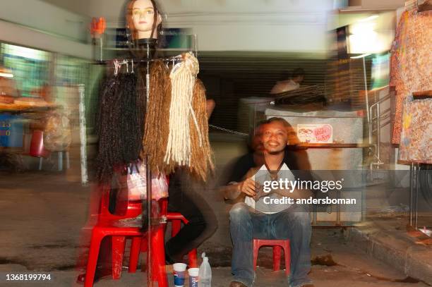 hair braiding in bangkok thailand - khao san road stock pictures, royalty-free photos & images