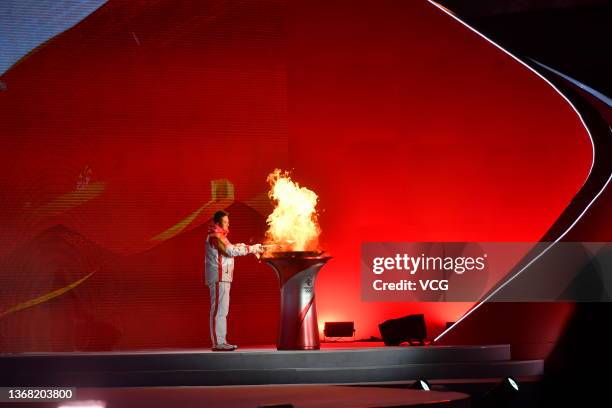 Ice maker Liu Boqiang carries the torch during the Beijing 2022 Olympic Torch Relay on February 2, 2022 in Beijing, China.