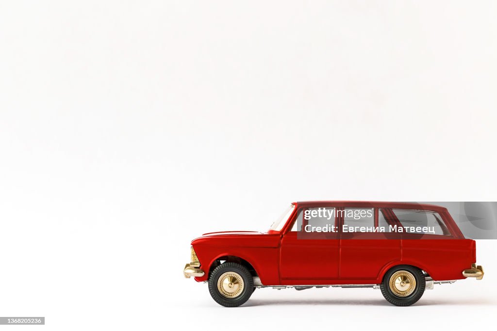 Red metal retro toy car on white background. Cars scale models collecting concept