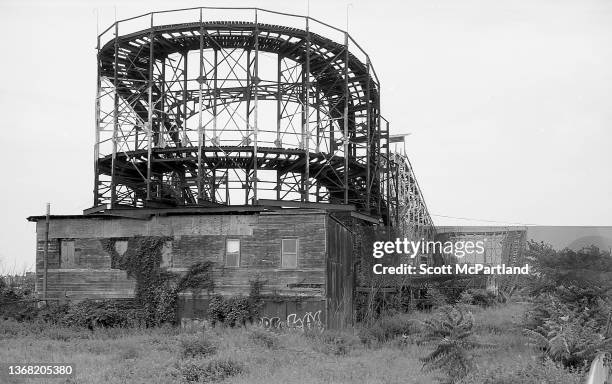 Rear view of the 'Cyclone' Roller Coaster at Coney Island, Brooklyn, New York, New York, June 24, 1995. Also visible at fore is overgrown vegetation...