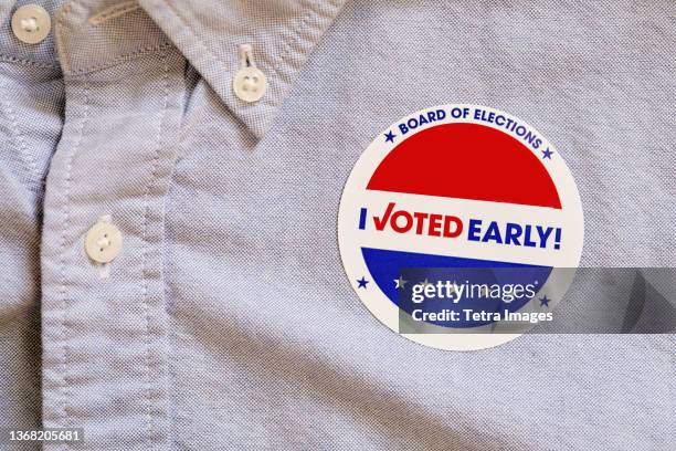 close-up of voting sticker on shirt - voting sticker stock pictures, royalty-free photos & images