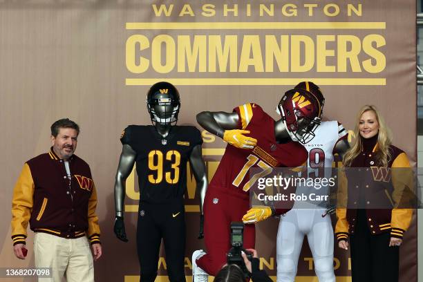 Team co-owners Dan and Tanya Snyder pose for a photo with the new team uniforms during the announcement of the Washington Football Team's name change...