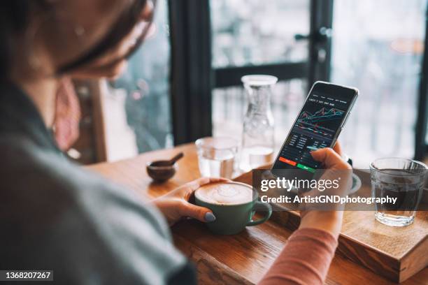 woman using smartphone buy cryptocurrency at a coffee shop, blockchain investment, decentralize and stock market concept. - exchange rate bildbanksfoton och bilder