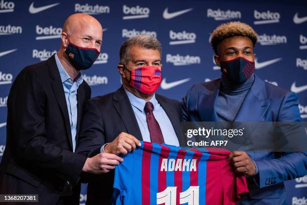 Jordi Cruyff, Joan Laporta and Adama Traore pose for photo during the presentation of Adama Traore as new player of FC Barcelona at Camp Nou stadium...